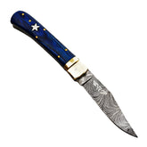 Ruddock Bros folding knife with blue hardwood handle and Damascus steel blade with spring assist includes leather sheath Ruddock El Paso Texas