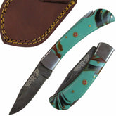 turquoise colored resin handle folding knife with Damascus steel blade  by Ruddock Bros El Paso Texas