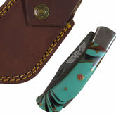 turquoise colored resin handle folding knife with Damascus steel blade  by Ruddock Bros El Paso Texas